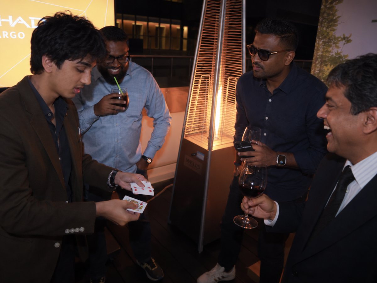 Vihaan performing close-up card magic for guests at a corporate dinner